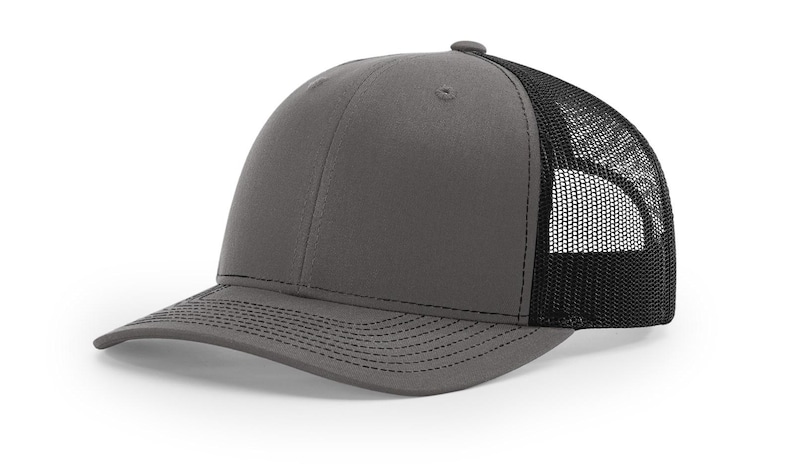 May include: A gray and black trucker hat with a mesh back. The hat has a curved brim and a structured crown.