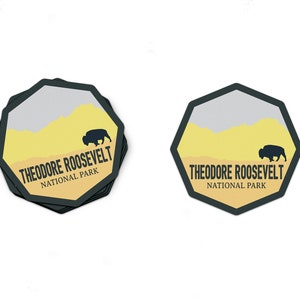 May include: A black and yellow sticker with a silhouette of a bison and the text "Theodore Roosevelt National Park".
