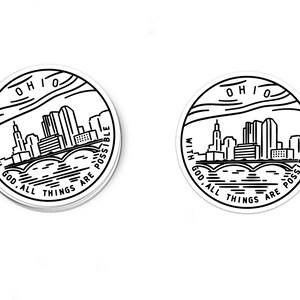 May include: Two black and white circular stickers with a skyline of a city and the text "With God, all things are possible" and "Ohio".