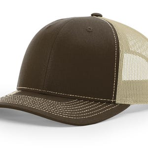 May include: A brown and beige trucker hat with a mesh back. The hat has a curved brim and a white stitching detail.