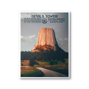 May include: A vintage-style poster for Devils Tower National Monument, featuring a scenic view of the iconic rock formation with a road leading towards it. The poster includes the text "Devils Tower National Monument, U.S. Department of the Interior, National Park Service".