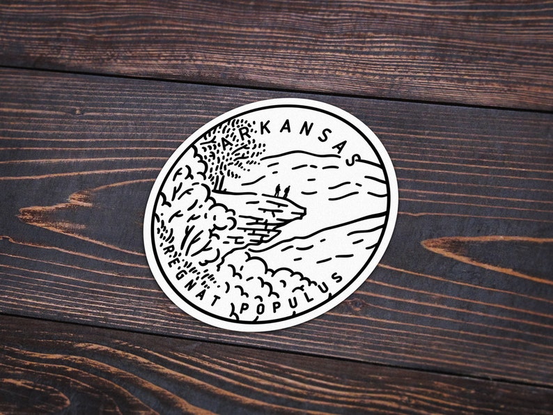 May include: Black and white illustration of a landscape with a river, trees, and hills. The text "KANSAS AD ASTRA PER ASPERA" is written around the edge of the circle.