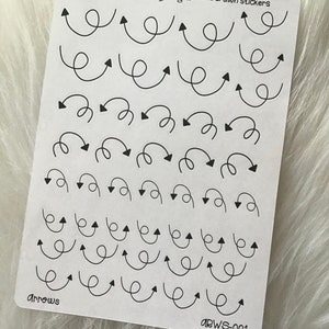 May include: A sheet of black and white hand-drawn arrow stickers. The arrows are in various styles and sizes. The sheet is labeled "Sparkle and Shine Designs hand drawn stickers" and "Arrows ARWS-001".