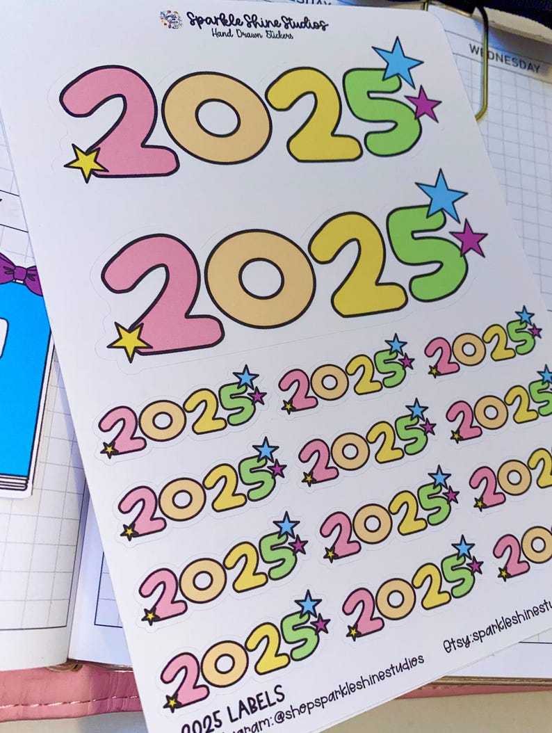 May include: A sheet of colorful 2025 stickers with a star design. The stickers are in pink, yellow, green, and blue. The text "2025 LABELS" is at the bottom of the sheet.