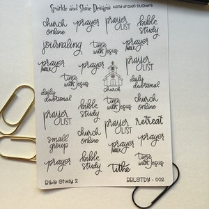 May include: A sheet of stickers with various religious phrases and designs, including "prayer", "bible study", "church", "time with Jesus", and "tithe". The stickers are printed in black ink on a white background. The text "Bible Study 2" and "BBLSTDY-002" are printed at the bottom of the sheet.