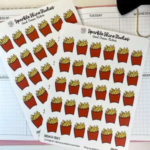 May include: A sheet of stickers featuring hand-drawn illustrations of french fries in red and yellow containers. The stickers are labeled "French Fries" and "Sparkle Shine Studios Hand Drawn Stickers".