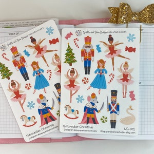 May include: A sheet of Nutcracker Christmas themed stickers featuring a nutcracker, a ballerina, a mouse king, a swan, a rocking horse, candy canes, snowflakes, and other festive elements. The stickers are white with colourful illustrations. The text "Nutcracker Christmas" and "Instagram @shesparkleshineshedies" is printed at the bottom of the sheet. The text "Otay sparkleshinestudies.etsy.com" and "NC-001" is printed at the bottom right corner of the sheet.