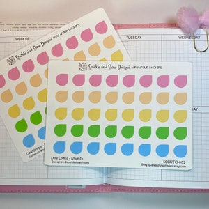 May include: Two sheets of stickers with a rainbow gradient of dew drop shapes. The stickers are labeled "Dew Drops" and "Dew Drops - Brights".