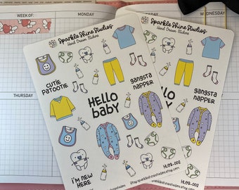May include: Three sheets of stickers featuring hand-drawn illustrations of baby items, including a onesie, bib, pacifier, and a tooth. The stickers are white with black outlines and colorful accents. The text on the stickers reads "Cutie Patoottie", "Gangsta Napper", "Hello Baby", and "I'm New Here".