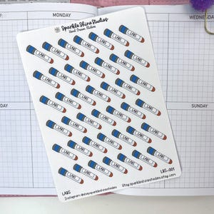 May include: A sheet of white stickers featuring a repeating pattern of blue and red lab markers with the word "LABS" printed on them. The stickers are from Sparkle Shine Studios.