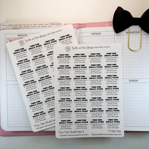 May include: A sheet of 30 black and white motivational stickers with the text "This Too Shall Pass" repeated on each sticker. The stickers are printed on white paper and are designed to be used in a planner or journal.