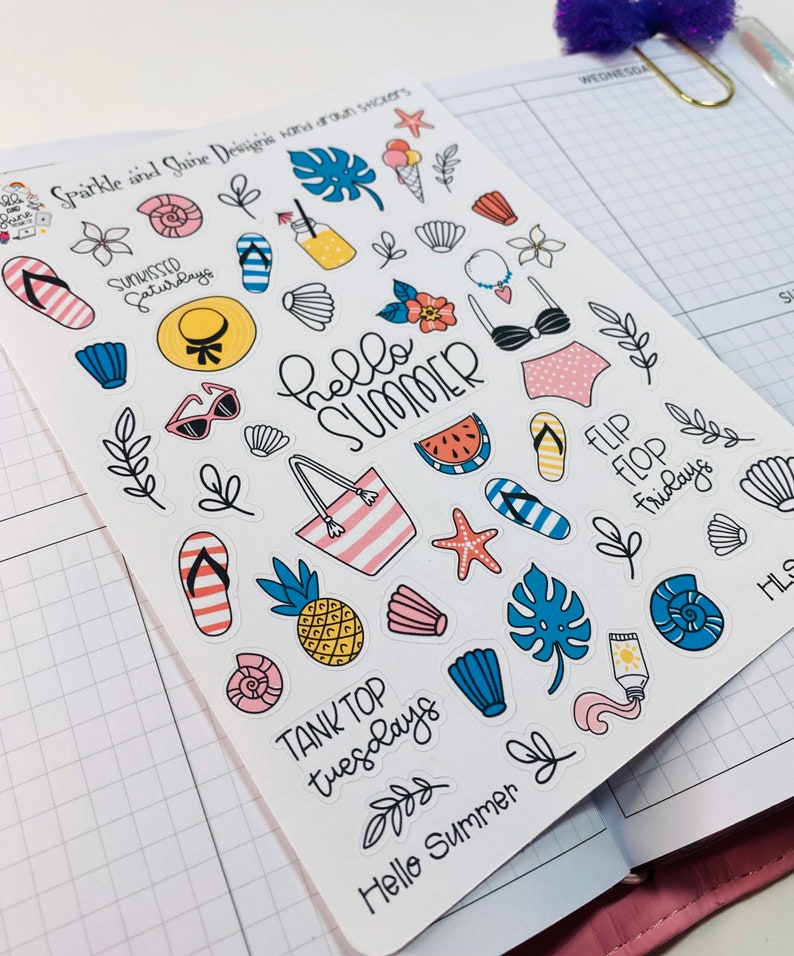May include: A sheet of colorful summer-themed stickers with various designs, including a pineapple, watermelon, flip flops, a beach bag, a seashell, a starfish, a palm leaf, and the text "Hello Summer".