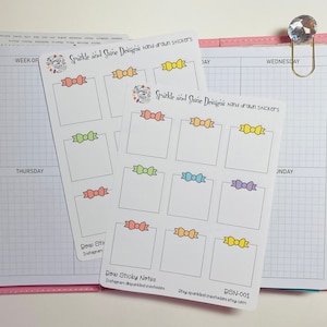 May include: Two sheets of stickers with blank squares and colorful bows. The stickers are labeled "Sparkle and Shine Designs hand drawn stickers".
