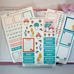 May include: A set of planner stickers featuring a fall theme with mushrooms, bows, and the text "It's Fall Y'all". The stickers are in shades of pink, blue, and green. The stickers are designed for use in a planner or journal.