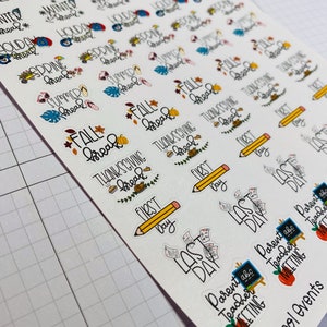 May include: A sheet of colorful stickers with various school-related themes, including "Fall Break", "Thanksgiving Break", "First Day", "Last Day", and "Parent Teacher Meeting".