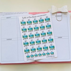 May include: A sheet of 36 stickers with a lake, trees, and a canoe design. Each sticker says "Get Outside" in black script. The sheet is white with a pink border and the text "Get Outside" and "GTOTSD-001" in black.