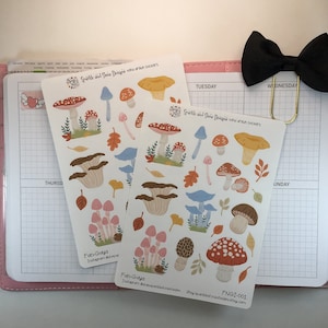 May include: Two sheets of stickers featuring hand-drawn illustrations of mushrooms in various colors and styles. The stickers are on a white background and have the text "Fun-Guys" and "FNGI-001" on them.