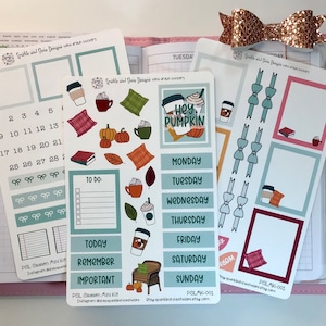 May include: A set of planner stickers featuring a fall theme with illustrations of pumpkins, coffee cups, leaves, and a plaid pillow. The stickers include a calendar, to-do list, and days of the week. The text "Hey Pumpkin" is featured on one of the stickers.