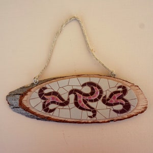 Wall mosaic ornament on natural wood.