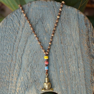 Beautiful boho handmade necklace with a brass buddha pendant and coconut beads