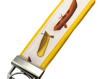 Personalized Canoe Keychain: Fabric Key Fob with Optional Initial Charms On Yellow Background