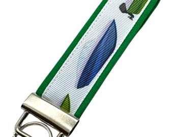 Personalized Motorboat Keychain: Fabric Key Fob with Optional Initial Charms on Green Background