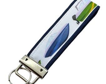 Personalized Motorboat Keychain: Fabric Key Fob with Optional Initial Charms on Blue Background