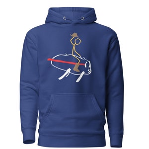 May include: A royal blue hoodie with a white stick figure riding a white bull with a red stripe. The stick figure is wearing a brown cowboy hat.