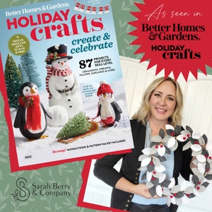 Op de afbeelding: Een tijdschriftcover met een knutselproject voor een pingu&iuml;n en een sneeuwpop. De cover vermeldt "Better Homes & Gardens Holiday Crafts: Create & Celebrate" en "87 Projects for Every Skill Level".