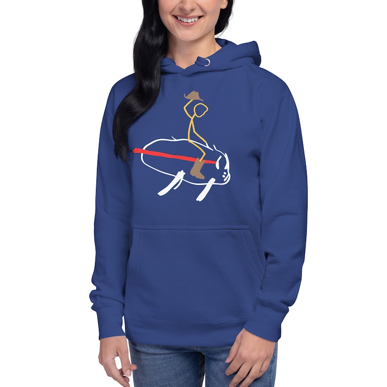 May include: A royal blue hoodie with a white stick figure wearing a cowboy hat riding a bull. The bull is white with a red line across its back.