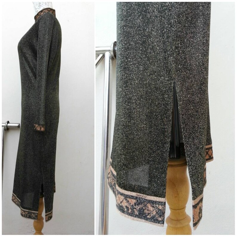 May include: A long, green, sparkly dress with a brown and black patterned trim. The dress has a slit up the back and a high neckline.