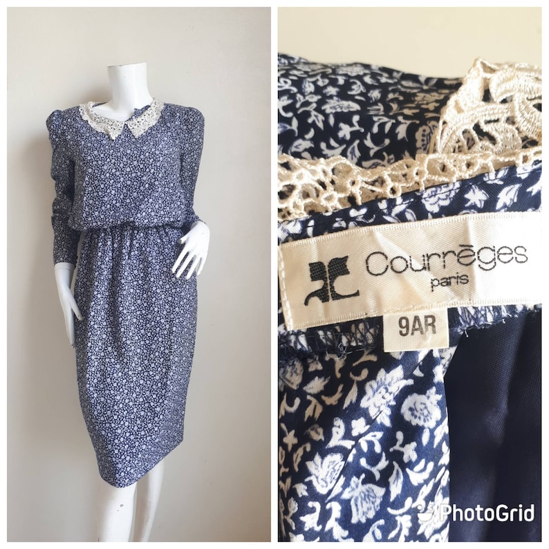 May include: A blue and white floral print dress with a white lace collar and long sleeves. The dress has a fitted bodice and a slightly flared skirt. The dress has a label that reads "Courr&egrave;ges Paris 9AR".