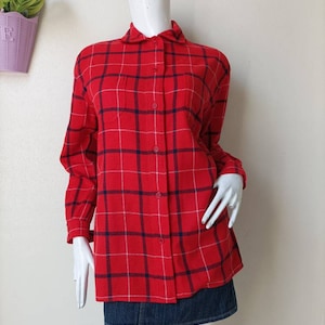 May include: A red and white plaid long-sleeved shirt with a blue and white checkered pattern. The shirt has a button-down collar and a chest pocket.