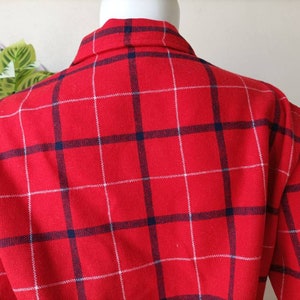 May include: Red and white plaid flannel shirt with a blue and white plaid pattern.