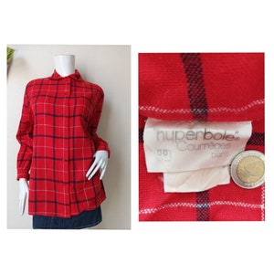May include: Red and white plaid flannel shirt with long sleeves and a button-down front. The shirt has a label that reads "hyperbole Courr&egrave;ges Paris".