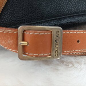 May include: A brown leather strap with a gold-toned buckle and the word "Courr&egrave;ges" engraved on it.