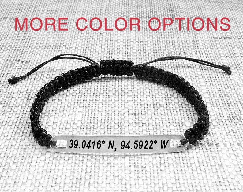 May include: Black braided bracelet with a silver tag engraved with the coordinates "39.0416&deg; N, 94.5922&deg; W".