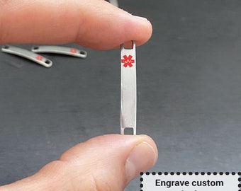 May include: A silver metal tag with a red medical symbol and the text "Engrave custom text, choose font from 14 available, add emoji or image for free."