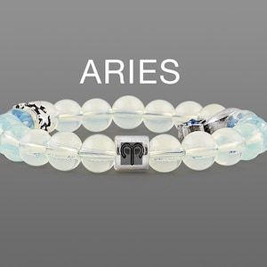 May include: A light blue beaded bracelet with a silver charm featuring the Aries zodiac symbol. The bracelet is made of opaque beads and has a silver clasp.