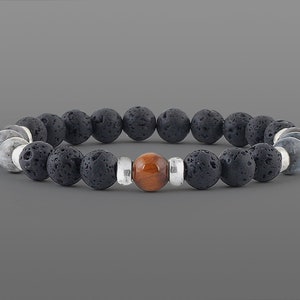May include: A black lava rock and silver bead bracelet with a single tiger's eye bead in the center.