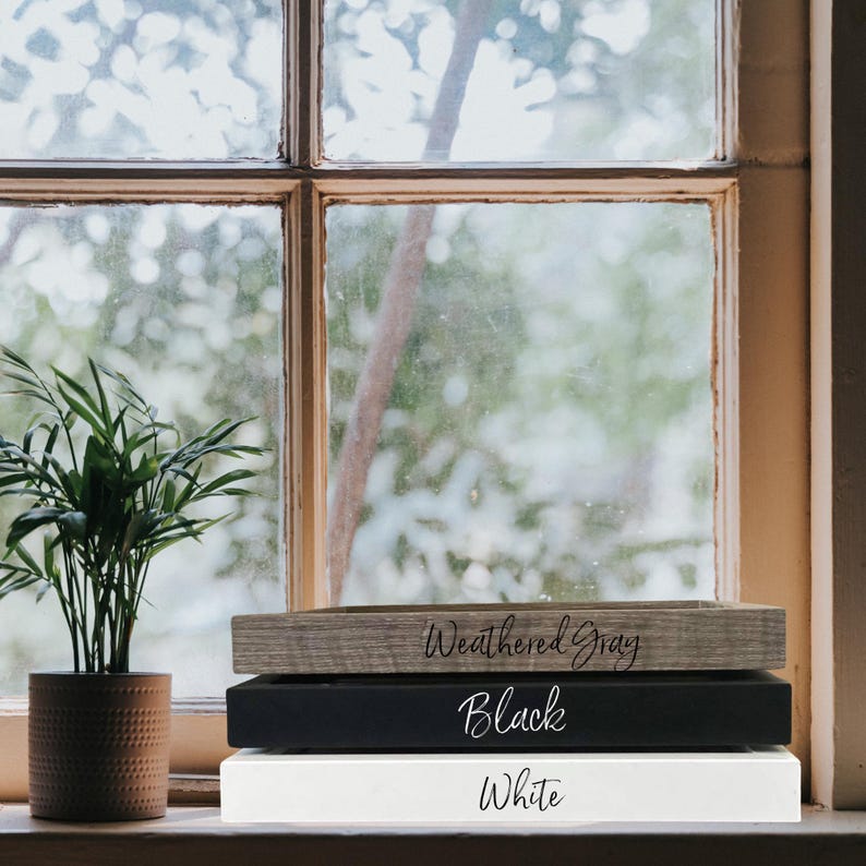 May include: Three wooden picture frames stacked on top of each other. The top frame is weathered grey, the middle frame is black, and the bottom frame is white. The frames are labelled with their colours: "Weathered Grey", "Black", and "White".