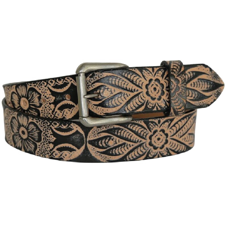 May include: A brown leather belt with a silver buckle. The belt is decorated with a black floral pattern.