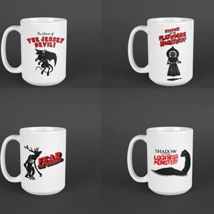 May include: Set of four white ceramic mugs with black and red illustrations of mythical creatures. The mugs feature the Jersey Devil, the Flatwoods Monster, the Wendigo, and the Loch Ness Monster.