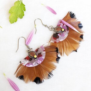 Stainless steel and bird feather earrings.
