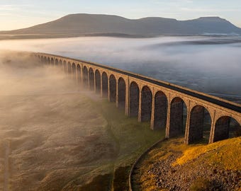 Yorkshire Dales national park, foggy morning at Ribblehead viaduct with Ingleborough rising in the distance. Wall art, landscape photography