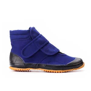 May include: Blue canvas high-top shoes with velcro closures and a black rubber sole.