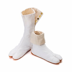 May include: A pair of white tabi socks with a split toe design. The socks are made of a soft, breathable fabric and have a comfortable fit. The socks are perfect for wearing with traditional Japanese clothing or for everyday wear.