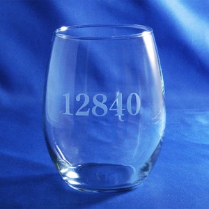 May include: Clear glass wine glass with the number 12840 etched on the side.