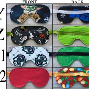 May include: A collection of four sleep masks labeled Y, Z, A1, and A2. Mask Y features a character print and Star Wars text. Mask Z has a Halloween pattern. Mask A1 displays a green snake crest on a white background. Mask A2 is solid red.