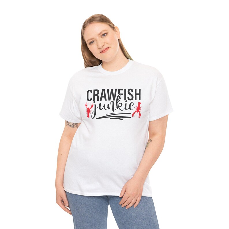 May include: White t-shirt with black text that reads "Crawfish Junkie" and two red crawfish illustrations.